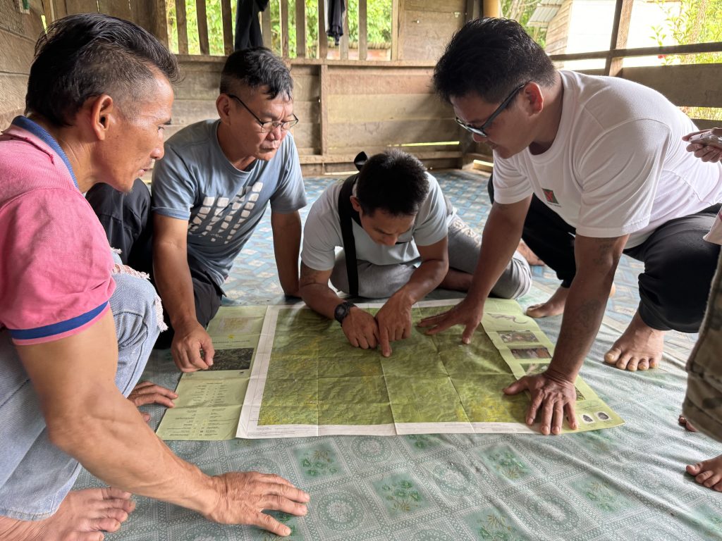 Long Pakan community members use BMF maps to show investigators where encroachment has occurred